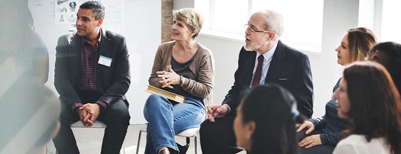 Group of people sitting in a circle talking