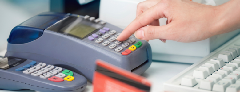 Hand pressing buttons on EFTPOS machine